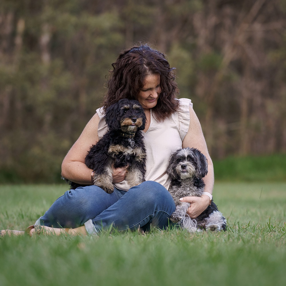 A client embracing her dog during their session